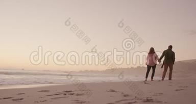 活跃的高级夫妇在海滩上散步